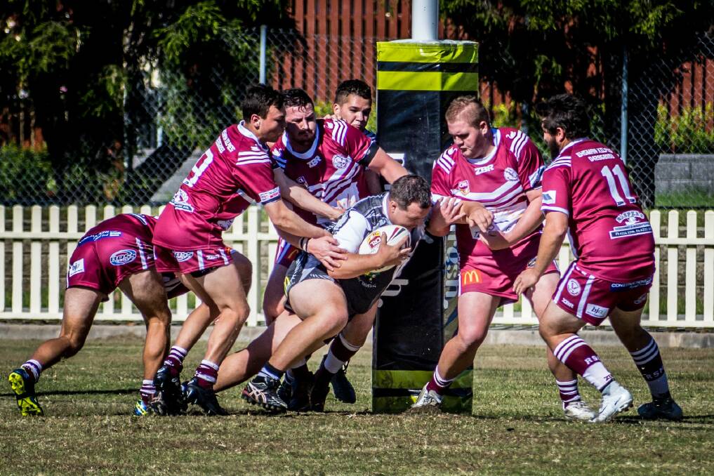 BACK-TO-BACK: Glen Innes forward Sam Schiffman is held up by Inverell defenders over the try line in Saturday's A grade encounter. Photo: Brenton Hodge.