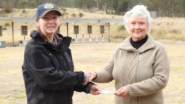 Legacy Australias Sandra McBain (right) accepts a cheque for monies raised at the ANZAC day shoot from SSAA Glen Innes Branch Secretary, Natalie Mills. 