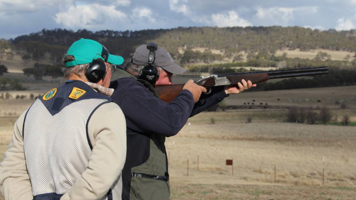 TRYING OUT SOMETHING NEW: Scott Slade being supervised by Geoff Jacobsen from Richmond River Gun Club who kindly assisted us on the day. Photo: Supplied. 