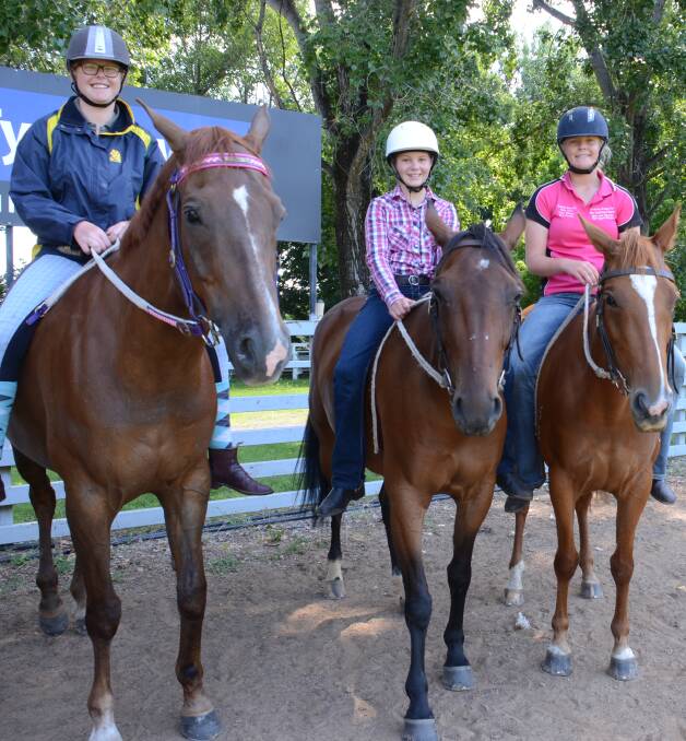 RIDING TO WIN: Team captain Rachel Kiehne, Jessica Wright and Siddella Donnelly hit the training paddock ahead of Jamboree.