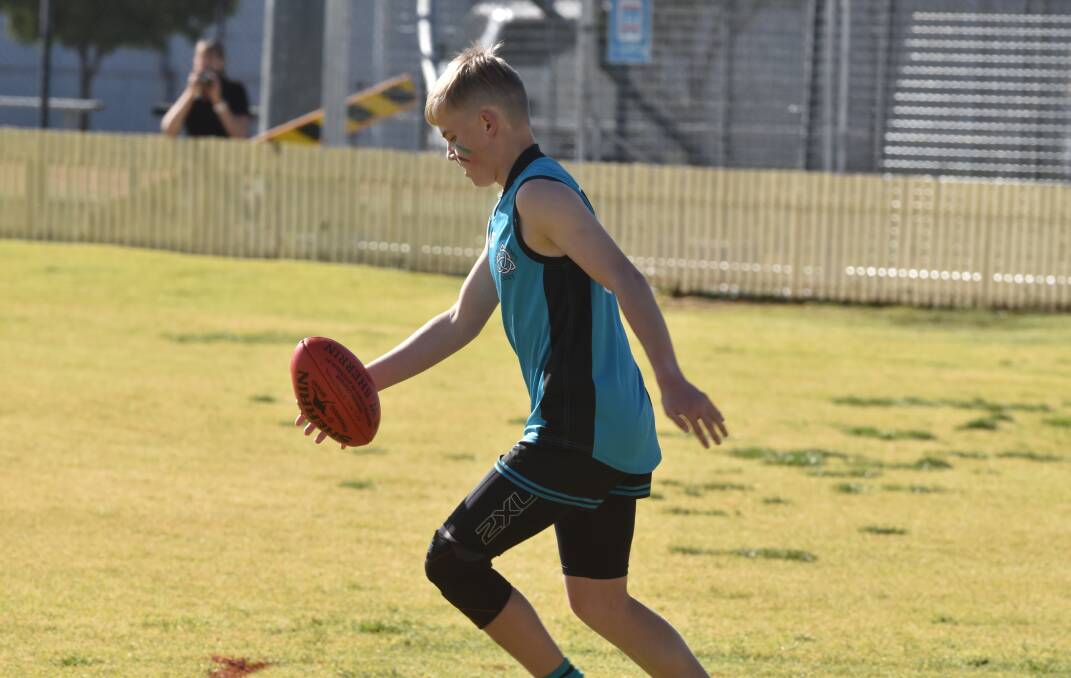 DEBUT YEAR: Oliver Quinn puts a kick in on Saturday in the under-14 grand final in Gunnedah. 