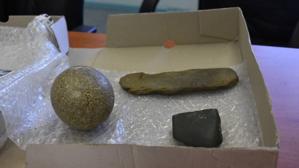 The stone on the left is a hammer stone, ofted used to create or sharpen other tools. The top one is a chisel, and the darker stone is an axe head.