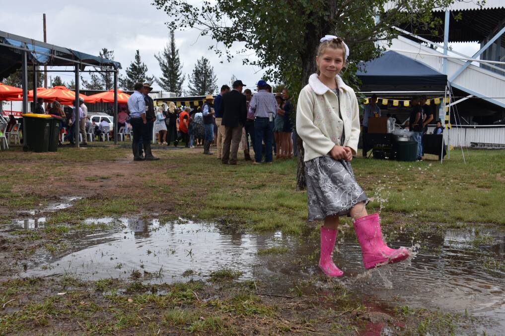RARE SIGHT: Nikita Owen walks through a puddle at the Deepwater races. Pictures: Andrew Messenger
