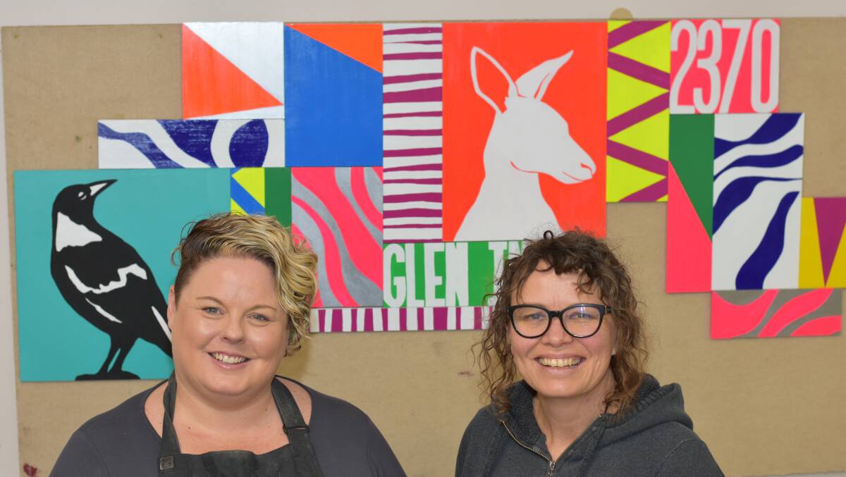 WORK IN PROGRESS: Sarah Fordham with teacher Abby Sparks in front of what will be the new colourful mural. 
