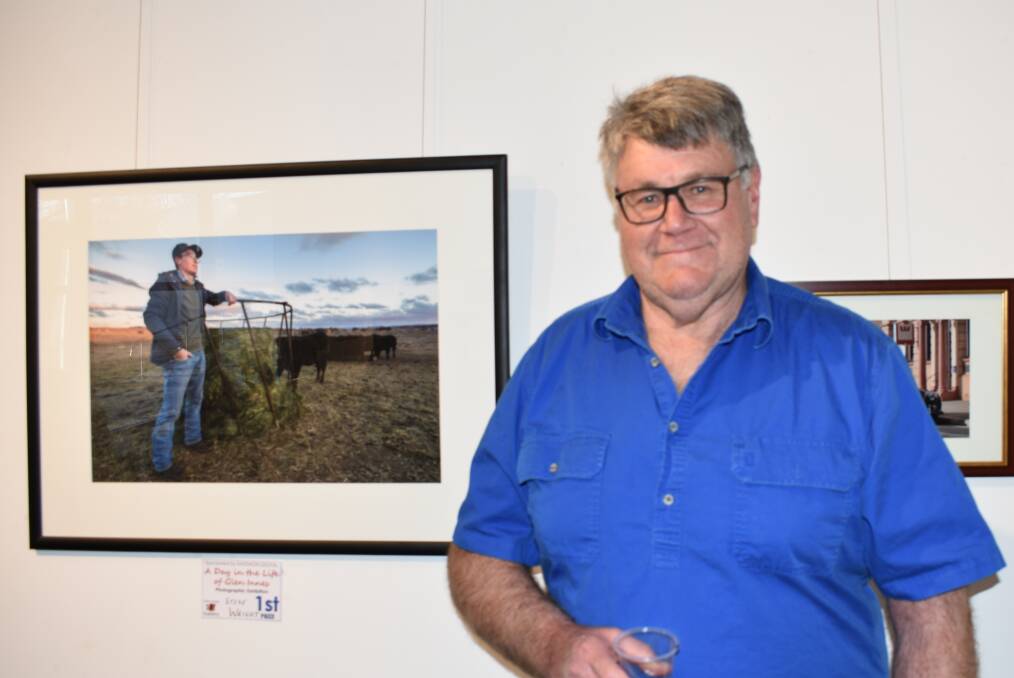FRAMED UP: Champion photographer Steve Wright standing next to his first prize winning photo of a day in the life of Glen Innes. Picture: Andrew Messenger. 