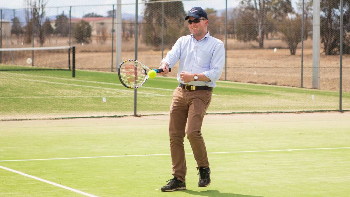 DRESSED FOR TENNIS: MP Adam Marshall hits a forehand at Deepwater's new tennis club.