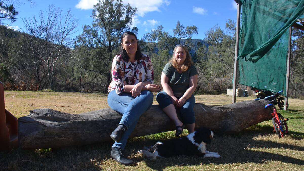 Helping hand: Social worker Amy Ware with Wytaliba resident Dannielle Monks. Ms Ware has committed to help out residents of the bushfire-affected community. 