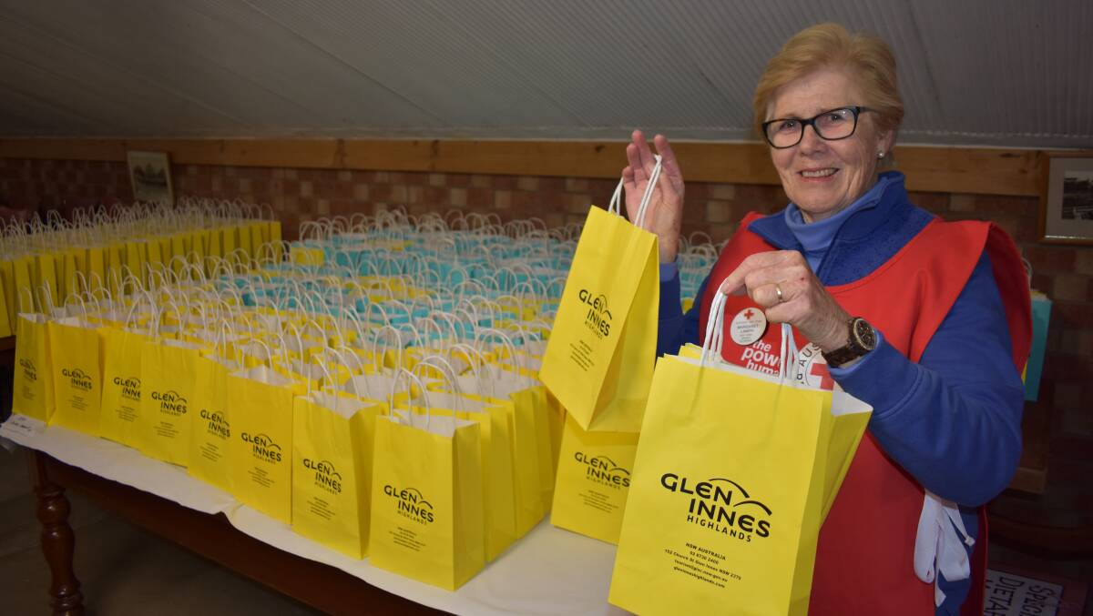 Margaret Lamph from Red Cross shows off lunch bags to be filled.