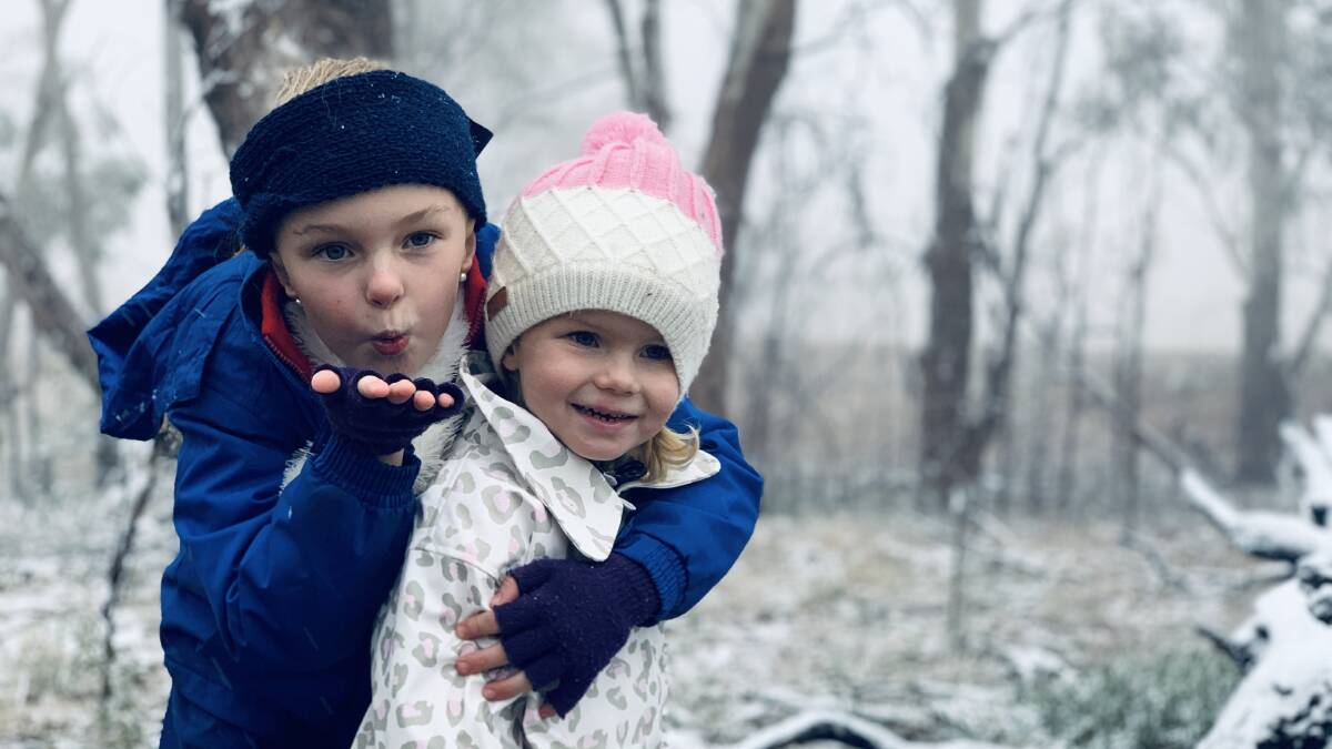 SNOW JOKE: Lali and Clover enjoy a white Glen Innes winter as the first snow in years falls on New England in June. Photo Jane Alt