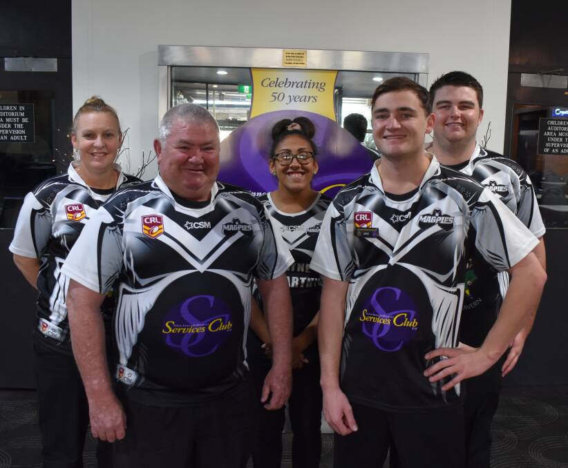 Employees of the Services Club have been all decked out in Magpies kit, including general manager Pat Lonergan (front left)