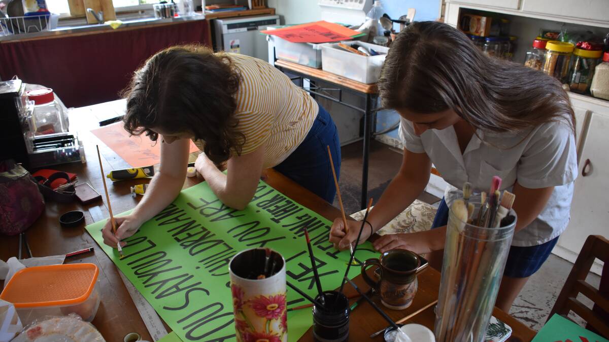 Callista Sheridan and Bethany Coulter are putting the finishing touches on their array of clever signs today.