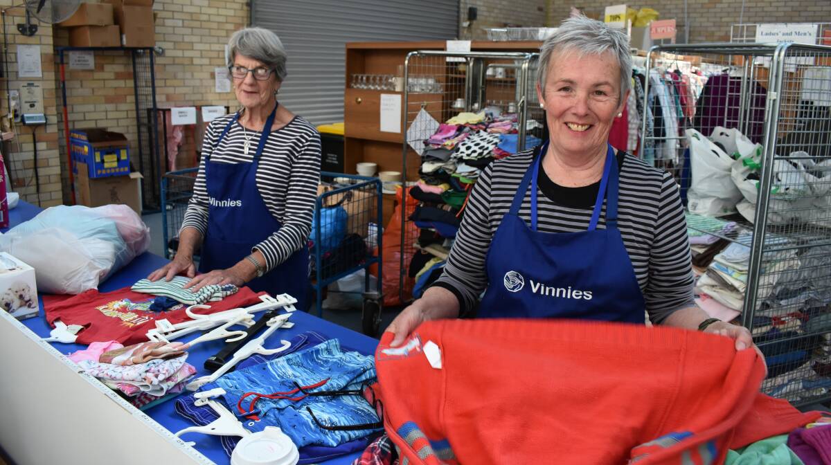 VOLUNTEERS: Joy Hartmann and Adi Ritchie sort some donated items at St Vincent de Paul Glen Innes. 