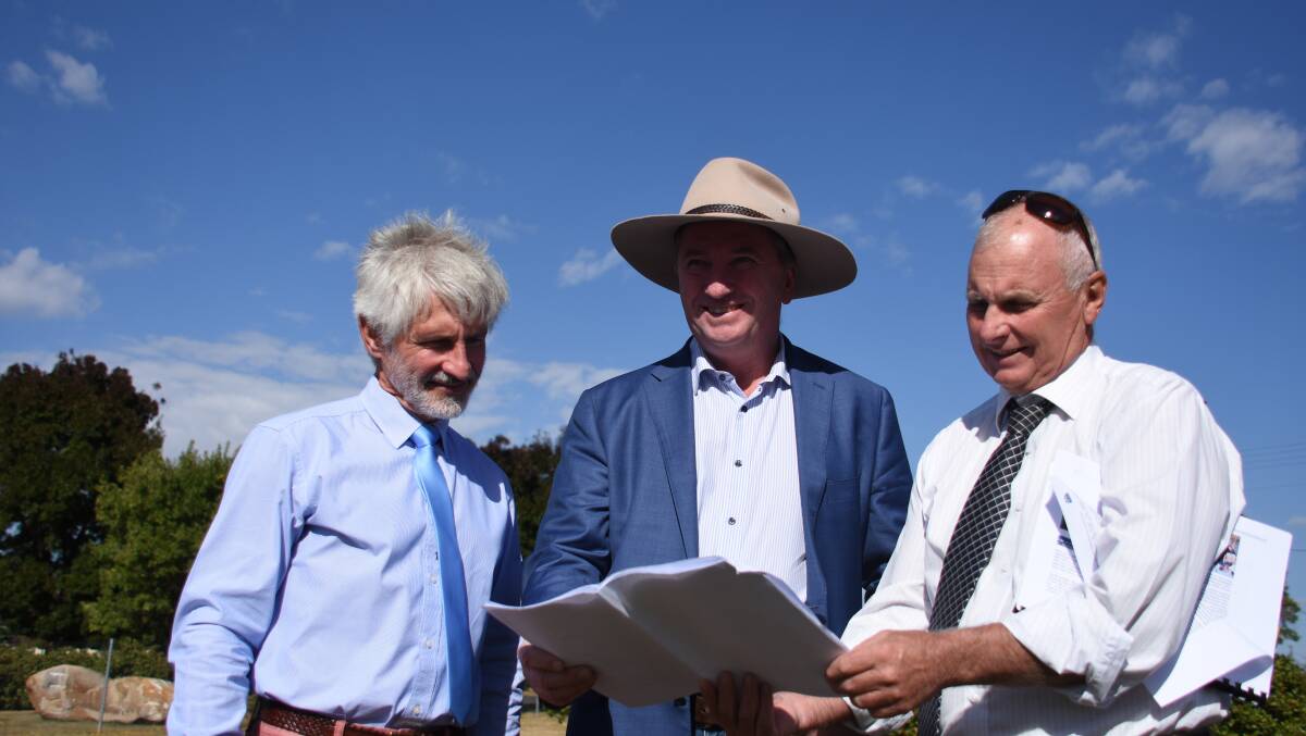 Hein Basson earlier this year assesses plans of the new netball facility with Member for New England Barnaby Joyce and acting GM Graham Price. 