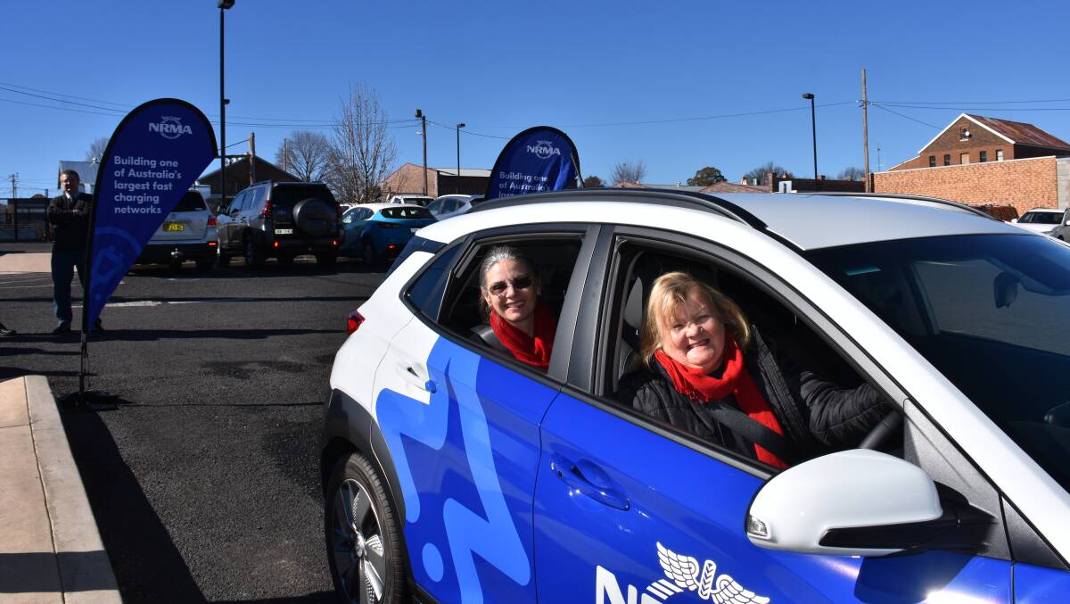 Mayor Sparks and NRMA's Nell Payne behind the wheel of an electric vehicle. It has 450 kms range.