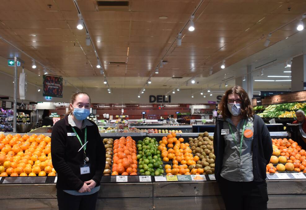 DOING THEIR BIT: Woolworth Glen Innes staff Rachael Skinner and Rebecca Wirth among those in the local team wearing masks in store. 