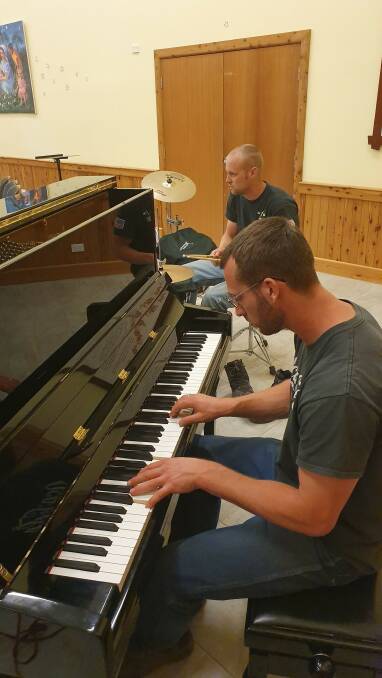Rehearsal in progress: Rufus Wareham at the piano and Wesley Wiser on drums during concert rehearsals at Danthonia Bruderhof.
