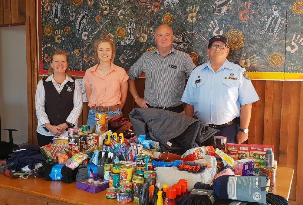 Senior Case Management Officer Jo Bailey, Olivia Adams from Pathfinders, Community Corrections Manager Mark Nott, and Correctional Officer Stuart Blyth with the donations.