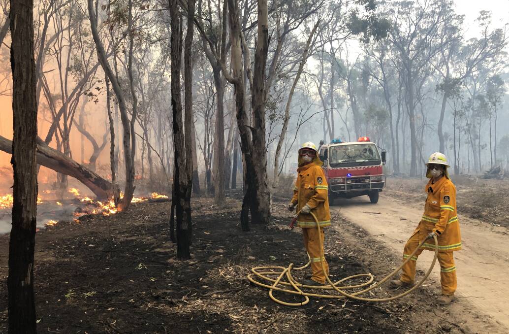 TAS RFS students Toby Smith and help set a containment line on the fire ground at
El Dorado. Picture supplied.