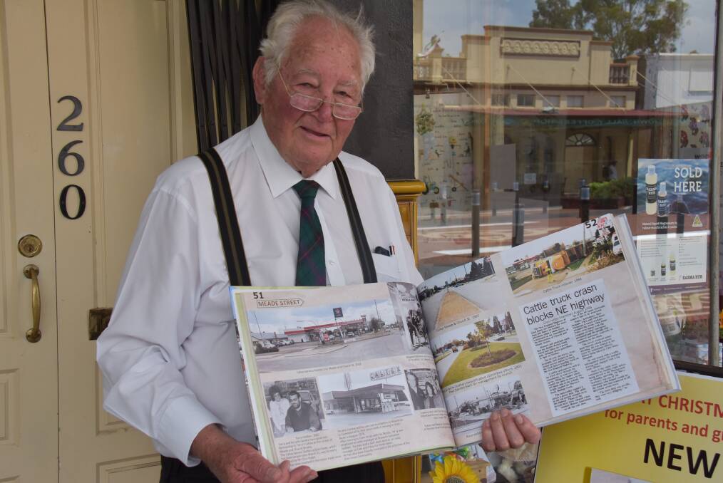 PAST TIMES: Howard Eastwood displaying the Historical Society's latest book, 100 years from Meade Street to Buccarumbi via the Gwydir Highway and Old Road. Photo: Nicholas Fuller