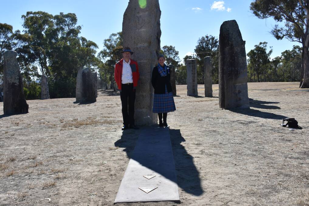 SOLSTICE STONE: Cr and Mrs Toms standing behind the plaque, shortly after solar noon. Photo: Nicholas Fuller