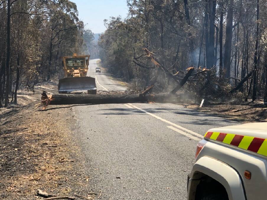 ROAD CLOSED: Falling trees still pose a risk after a fire torn through bush along Waterfall Way. Photo: New England Rural Fire Service