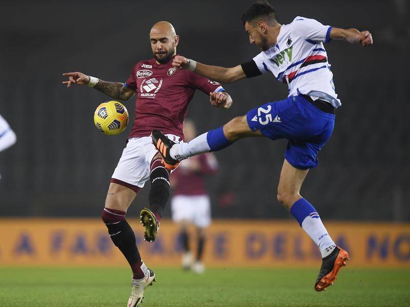 Torino's Simone Zaza and Sampdoria's Alex Ferrari vie for the ball during their Serie A meeting.
