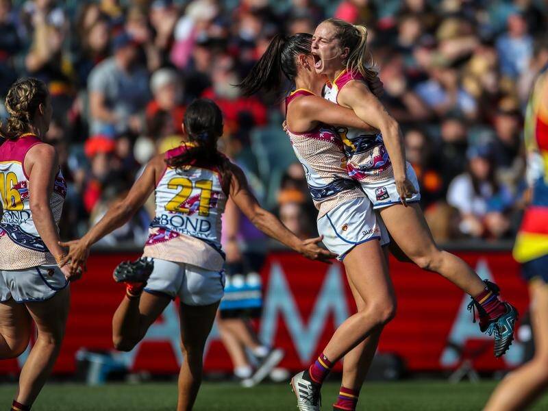 The Lions celebrate winning the AFLW decider by 18 points against the Crows in Adelaide.