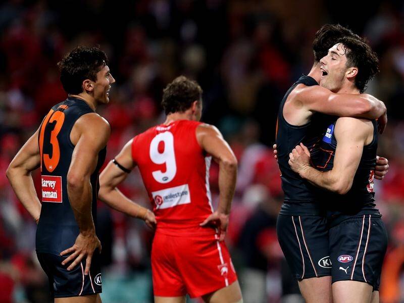 Giants players celebrate winning the 20th Sydney derby against the Swans in a thriller.