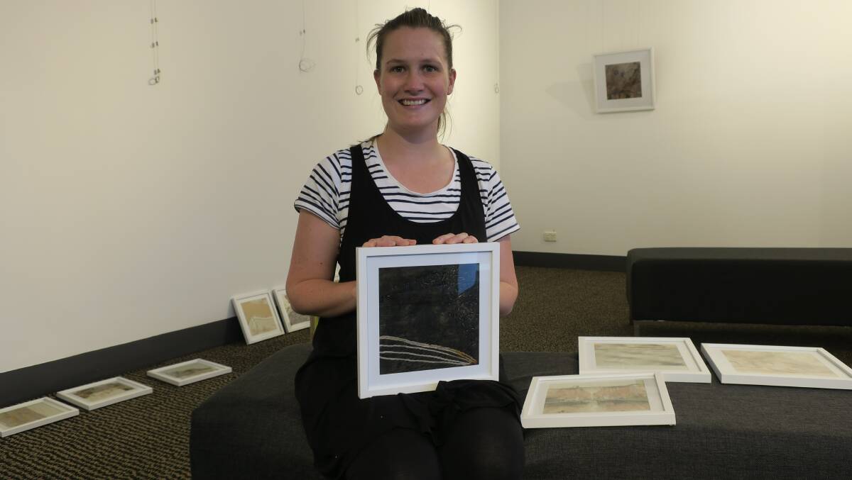 Stephanie McIntosh, preparing her exhibition at the Art Gallery in the Library.