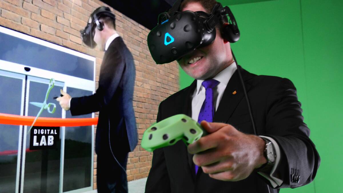 MP Adam Marshall cuts the virtual ribbon. In the VR visor, he sees the ribbon even though it doens't exist in hard form.