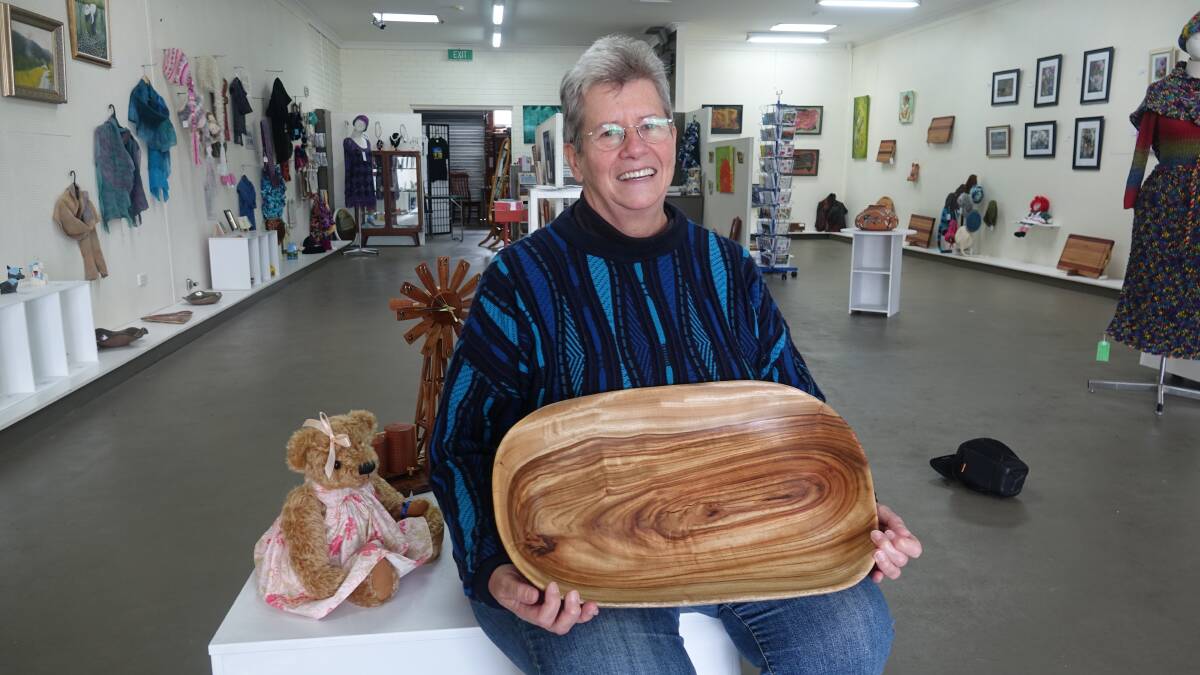 Marjorie Leggett with a bowl carved by Lindsay Smith.
