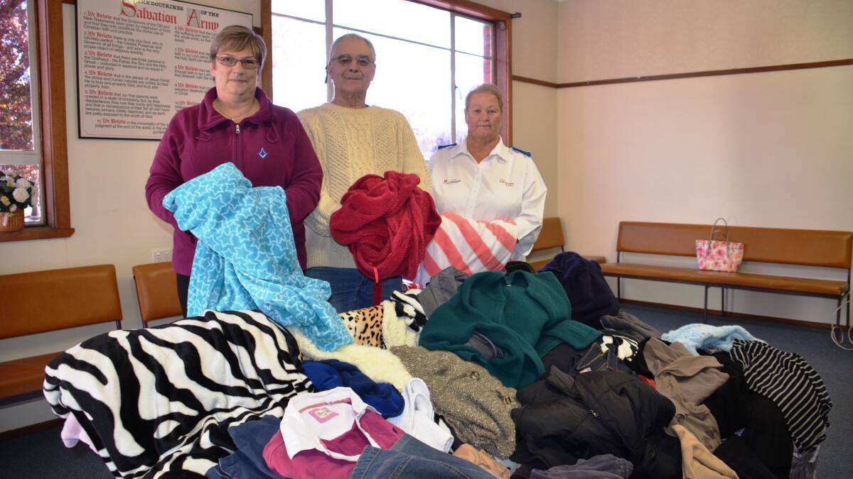 Christl Haron and Simon Kerry from the Glen Innes Masonic Lodge donate warm items to Yvonne Proctor for the Salvation Army’s ‘winter warm appeal’.