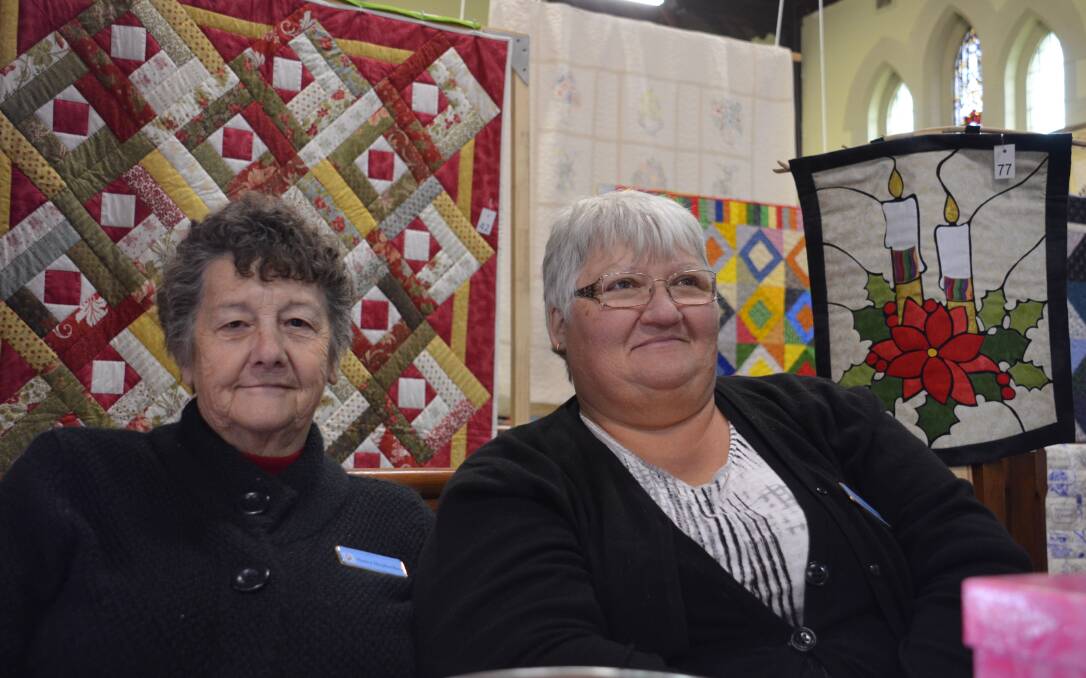 Nancy Shepherdson and Chris Martin gather the public votes to award the People's Choice best quilt.