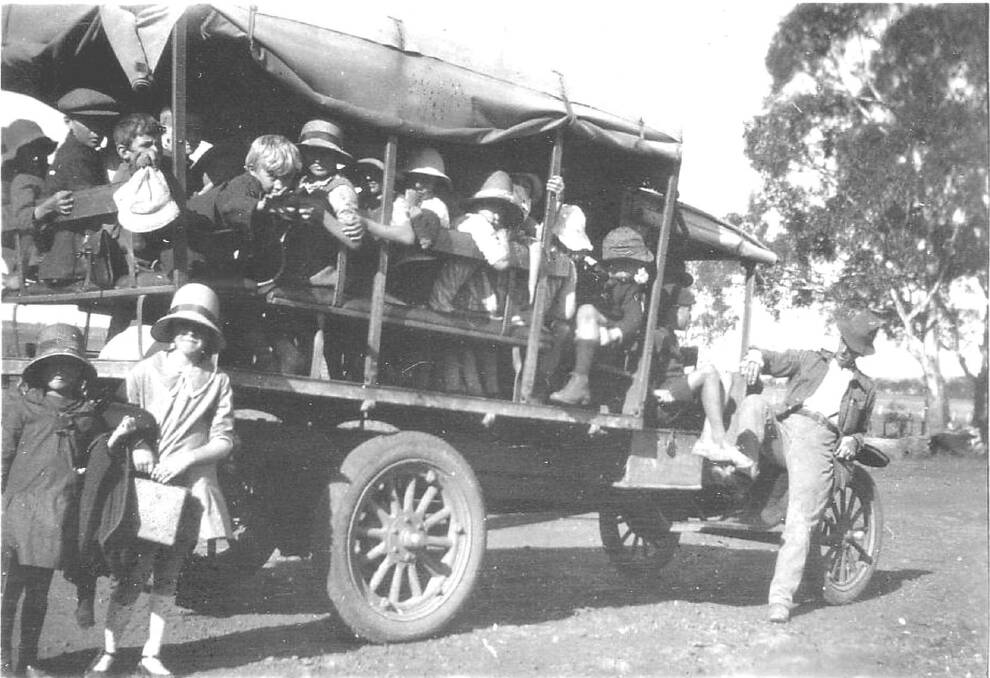Legs inside the bus: A gentleman makes his point about safe travel on a Furracabad school bus in the 1930s.