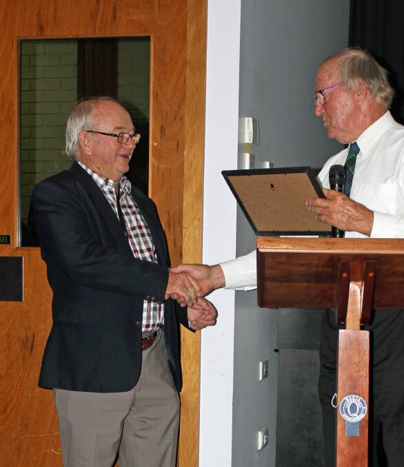 Graham Wilson receives his award from Malcolm Wehr.